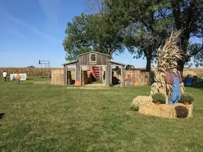 The straw bale barn with a red staircase