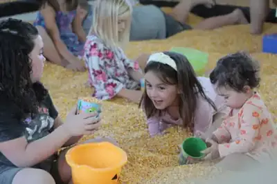 Children playing in the corn pit