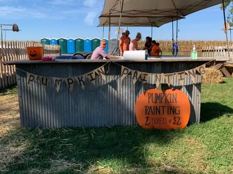 The pumpkin painting stand with its hand-lettered banner