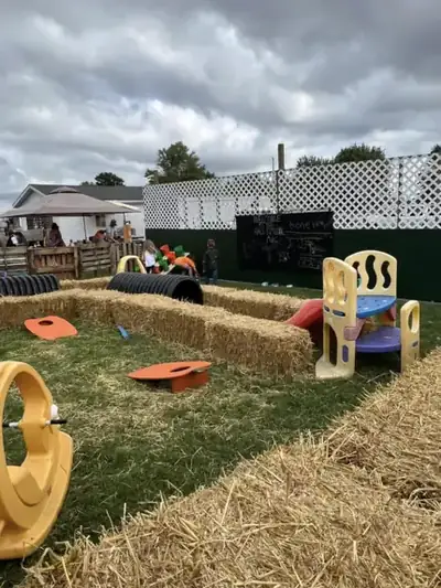 The toddler play area with hay bales and small slides